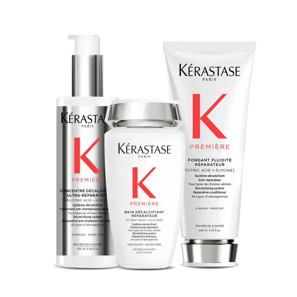 Kérastase hair repair products: shampoo, conditioner, and serum in white bottles.