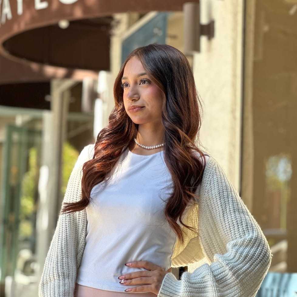 Portrait of Saray Vega, a professional stylist at Mark Taylor Salon & Spa, showcasing their expertise and style.