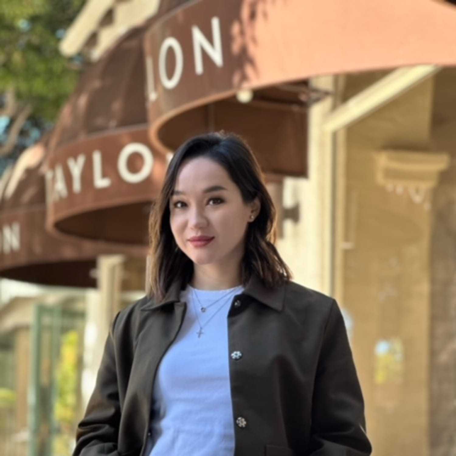 Portrait of Damesh Seitzhaparova, a professional stylist at Mark Taylor Salon, showcasing their expertise and style.