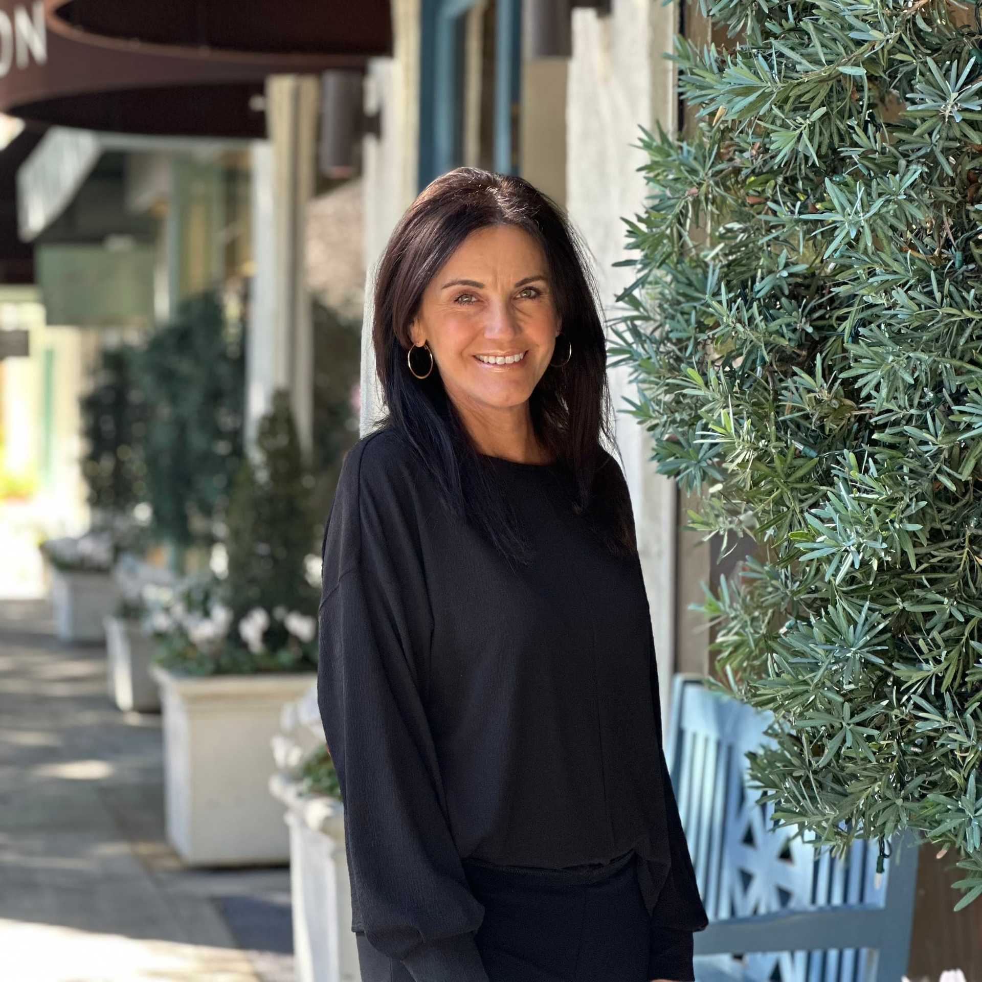 Portrait of Gina Miller, a professional stylist at Mark Taylor Salon & Spa, showcasing their expertise and style.